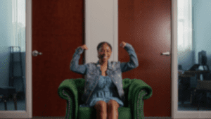 Girl does strong pose while sitting on green chair. Strong Enough to Heal Grow Change